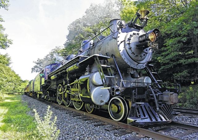 The thunderous roar of steam locomotive, billowing smoke and transporting  people and goods along winding railway, a reminder of power and beauty of  this majestic train on tracks, AI Generative 31570260 Stock