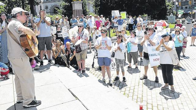 Louis Gilio, Old Forge, sings his song, &#8216;Break Down the Barriers,&#8217; at the Families Belong Together rally at Public Square in Wilkes-Barre on Saturday afternoon. Activists were protesting the immigration policies of President Donald Trump. Tony Callaio | For Times Leader 