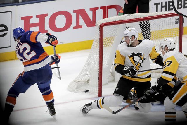New York Islanders right wing Josh Bailey (12) skates by the bench after  scoring a goal Pittsburgh Penguins during the third period of Game 2 of an  NHL hockey first-round playoff series