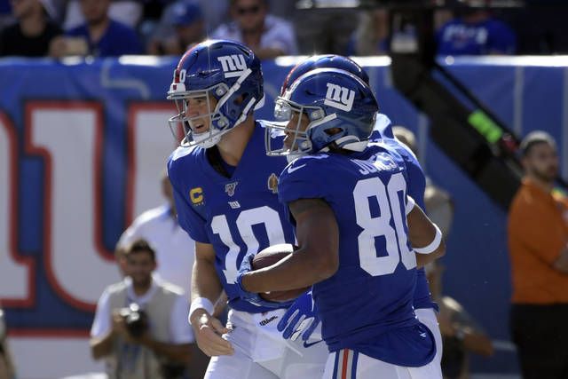 New York Giants starting quarterback Eli Manning rolls out to the right  against the Washington Redskins in the first quarter at Giants Stadium in  East Rutherford, New Jersey on December 16, 2007. (