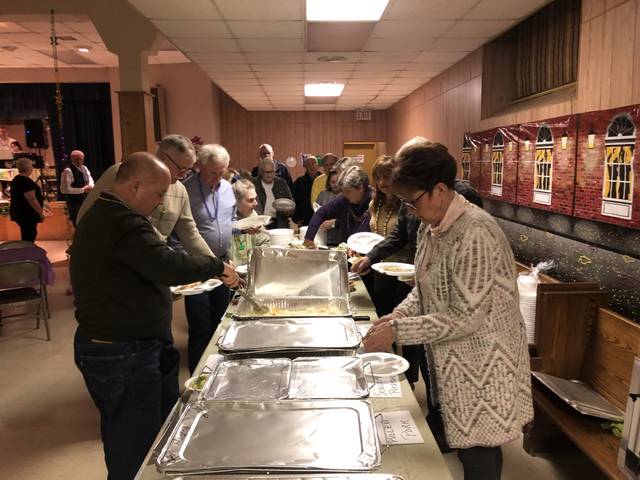 <p>Guests at Saturday’s Mardi Gras celebration at the St. Robert Bellarmine parish line up for food.</p> <p>Kevin Carroll | Times Leader</p>