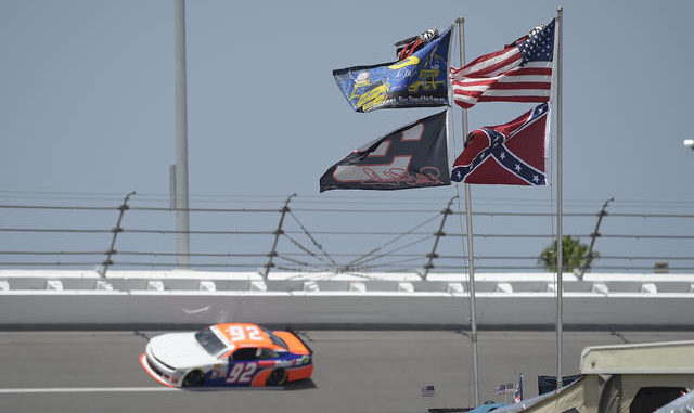  U.S., Confederate and Dale Earnhardt Sr. and Jr. flags fly near Turn 4 at Daytona International Speedway. NASCAR banned the Confederate flag from its races and venues Wednesday formally severing itself from what for many is a symbol of slavery and racism. Phelan M. Ebenhack | AP file photo 