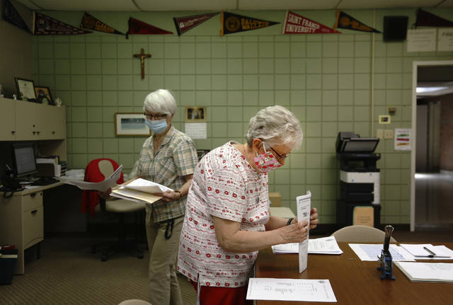 <p>Guidance secretary Marge Berckmiller, left, and Sister Bridget Reilly, director of guidance, prepare student transcripts to send to other schools after the closure of Quigley Catholic High School in Baden, Pa. on Monday, June 8, 2020. The staff learned of the closure May 29 via videoconference.</p> <p>Jessie Wardarski | AP photo</p>