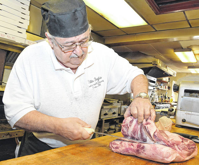 <p>Bernie Foglia prepares pork for a dinner special at Villa Foglia in this file photo from 2016.</p> <p>Tony Callaio | File photo</p>