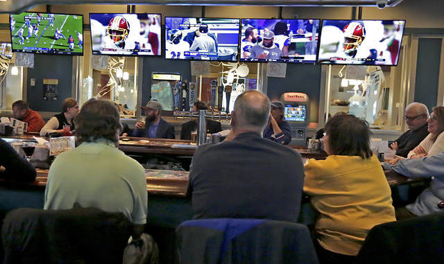  Patrons watch NFL games on televisions at SkyBox Sportsbar inside Grotto Pizza in Wilkes-Barre Township in this 2017 file photo. Times Leader file photo 