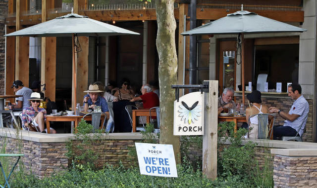  People gather at the Porch in the Oakland neighborhood of Pittsburgh on Sunday. In response to the recent spike in COVID-19 cases in Allegheny County, health officials are ordering all bars and restaurants in the county to stop the sale of alcohol for on-site consumption beginning on Tuesday afternoon. Gene J. Puskar | AP photo 