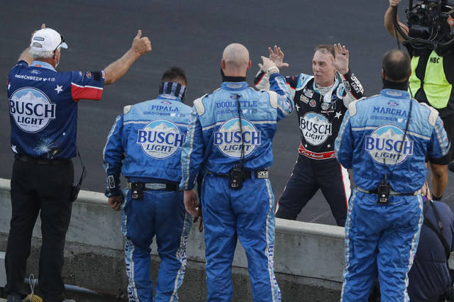 <p>Kevin Harvick, on far side of wall, celebrates with his crew after winning the NASCAR Cup Series race at Indianapolis Motor Speedway in Indianapolis on Sunday.</p> <p>AP photo</p>