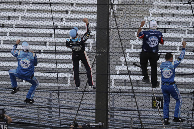 <p>Kevin Harvick, second from left, and some members of the team’s crew climb the fence after Harvick won the NASCAR Cup Series race at Indianapolis Motor Speedway in Indianapolis on Sunday.</p> <p>AP photo</p>