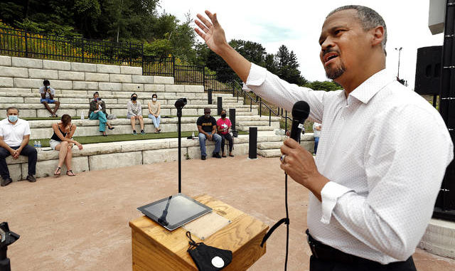  Pastor Samuel Washington, of the Perspective Church, talks about the lives of COVID-19 victims at the amphitheater located behind the Pittston Library on Sunday. Fred Adams | Times Leader 