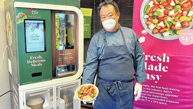 <p>Kang Kuan, vice president of culinary at Chowbotics, holds a custom salad made by his company’s robotic salad-making kiosk at the company’s headquarters in Hayward, Calif. Prior to this year, Chowbotics had sold over 100 of its $35,000 robots, primarily to hospitals and colleges. But since the coronavirus hit, sales have jumped more than 60%, CEO Rick Wilmer said, with growing interest from grocery stores, senior living communities and even the U.S. Department of Defense.</p>