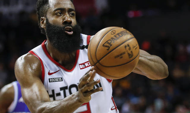  In this Saturday, March 7, 2020, file photo, Houston Rockets guard James Harden passes against the Charlotte Hornets during the second half of an NBA basketball game in Charlotte, N.C. Harden practiced with his teammates for the first time this summer, Thursday, July 16, 2020, after arriving later than most of the Rockets for the season restart at Walt Disney World. (AP Photo/Nell Redmond, File) 