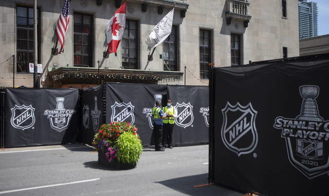  Security guards stand by at a section of the street outside Torontos Royal York hotel, which is closed off as NHL teams arrive at the bubble ahead of the return of the leagues season following a disruption due to the COVID-19 pandemic, in Toronto on Sunday. AP photo 
