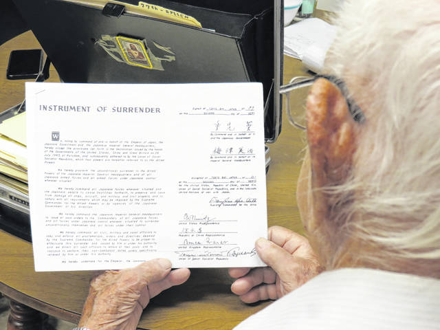 <p>World War II veteran Bob Megatulski holds a reproduction of the instrument of surrender between Japan and the Allied powers, formally ending the war on Sept. 2, 1945. Hostilities effectively ended on Aug. 14-15, 1945, 75 years ago this weekend.</p> <p>Roger DuPuis | Times Leader</p>