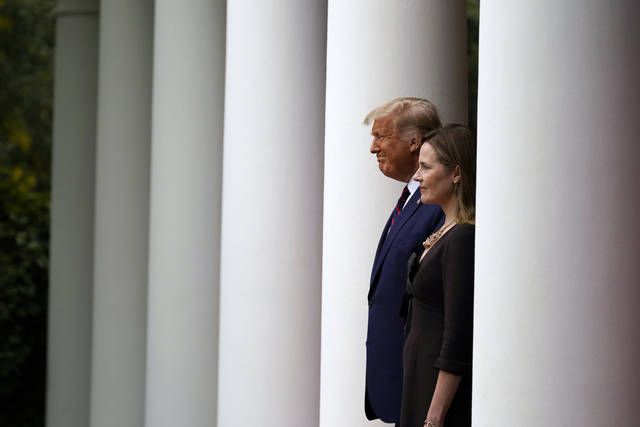 
			
				                                President Donald Trump walks with Judge Amy Coney Barrett to a news conference to announce Barrett as his nominee to the Supreme Court on Saturday in Washington.
 
			
		