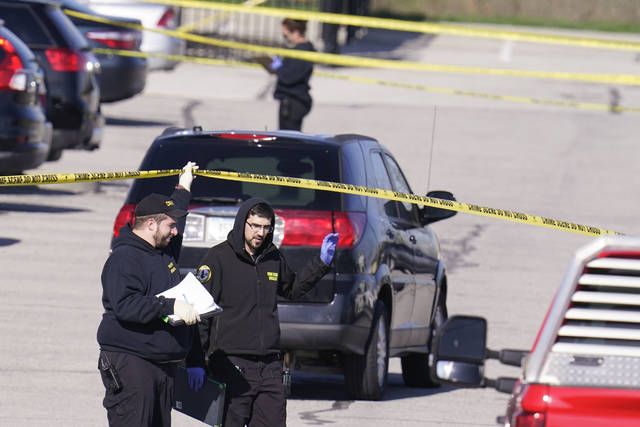 <p>Authorities confer at the scene where multiple people were shot at the FedEx Ground facility early Friday morning, April 16, 2021, in Indianapolis. A gunman killed eight people and wounded several others before apparently taking his own life in a late-night attack at a FedEx facility near the Indianapolis airport, police said, in the latest in a spate of mass shootings in the United States after a relative lull during the pandemic. (AP Photo/Michael Conroy)</p>