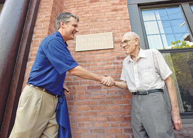 <p>Harold E. Cox, right, was honored by Wilkes University in 2015 with the dedication of a building in his name. Shaking Cox’s hand is then-Wilkes President Patrick Leahy.</p>
                                 <p>Times Leader file photo</p>