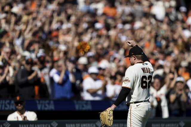 San Francisco Giants starting pitcher Logan Webb acknowledges the fans as he leaves the field in the eighth inning of a game against the San Diego Padres in San Francisco on Sunday.
                                 AP photo