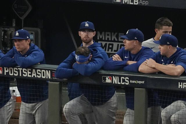 Los Angeles Dodgers watch the ninth inning from their dugout against the Atlanta Braves in Game 6 of the National League Championship Series on Saturday in Atlanta.
                                 AP photo