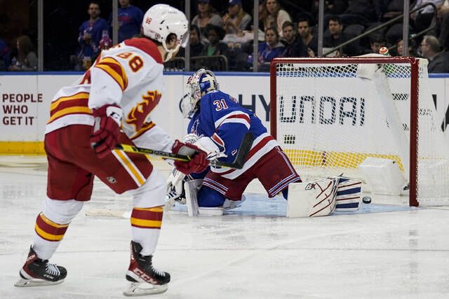 
			
				                                Calgary Flames left wing Andrew Mangiapane scores against New York Rangers goaltender Igor Shesterkin during the second period of an NHL game Monday in New York.
                                 AP photo

			
		