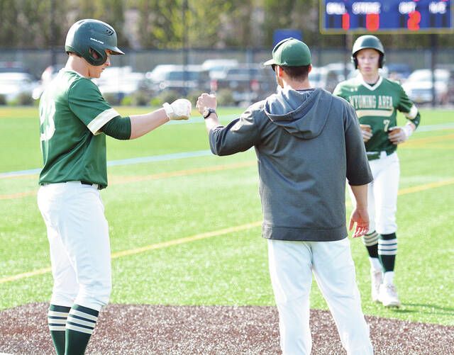 <p>Wyoming Area coach Rob Lemoncelli congratulates Joey Colarusso (23) on third base as he calls in his runner, Casey Noone (7), during a timeout in the fourth inning Wednesday. Both scored on a triple by Jack Mathis.</p>
                                 <p>Tony Callaio | For Times Leader</p>