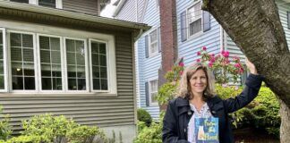 
			
				                                Suzanne Jones holds a copy of her Agnes memoir, ‘From the Flood,’ outside the Kingston home where her family eventually settled after several years of upheaval following the 1972 disaster.
                                 Roger DuPuis | Times Leader

			
		