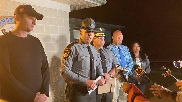 Pennsylvania State Police Troop N Public Information Officer Anthony Petroski, center, speaks late Saturday night during a press conference outside PSP Shickshinny, where the suspect in the Berwick and Nescopeck incidents was being held.
                                 Kevin Carroll | Times Leader