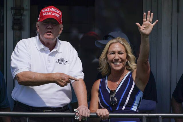 
			
				                                Rep. Marjorie Taylor Greene, R-Ga., waves while former President Donald Trump points to her in Bedminster, N.J., July 30. Greene will be attending Trump’s Saturday rally at Mohegan Sun Arena in Wilkes-Barre Township.
                                 AP file photo

			
		