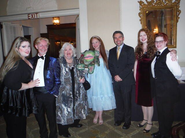 Celebrating at the Westmoreland Club are, from left, Jessica and Scott Colin Woolnough, Toni Jo Parmelee, Maureen Franko holding Audrey, the plant from Little Shop of Horrors, Tom Franko, Deirdre Lynch Navin and Meg Davis.
                                 Mary Therese Biebel | Times Leader
