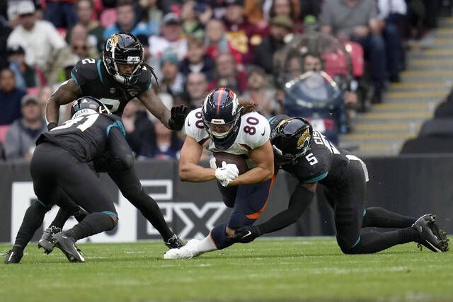 Denver Broncos linebacker Jonathan Kongbo (90) walks off the field after an  NFL football game against the Jacksonville Jaguars at Wembley Stadium in  London, Sunday, Oct. 30, 2022. The Denver Broncos defeated