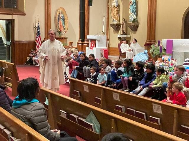 
			
				                                Rev. Joseph Verespy welcomed young parishioners to the altar during Tuesday night’s St. Nicholas feast day Mass at St. Nicholas Church in Wilkes-Barre.
                                 Kevin Carroll | Times Leader

			
		