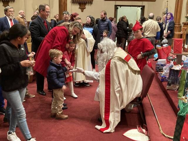 <p>The man of the hour, Saint Nicholas entered the church at the end of Tuesday’s Mass and greeted the parish’s children with candy and gifts.</p>
                                 <p>Kevin Carroll | Times Leader</p>