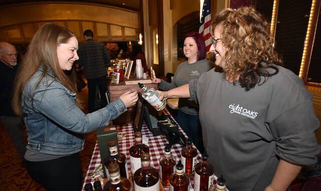 <p>Cat Sokirka, left, was happy to taste a sample from Eight Oaks Farm Distillery. Left to right: Sokirka, Michele Huzela Keiser, and Tonya Capizzi pouring.</p>
                                 <p>Tony Callaio | For Times Leader</p>
