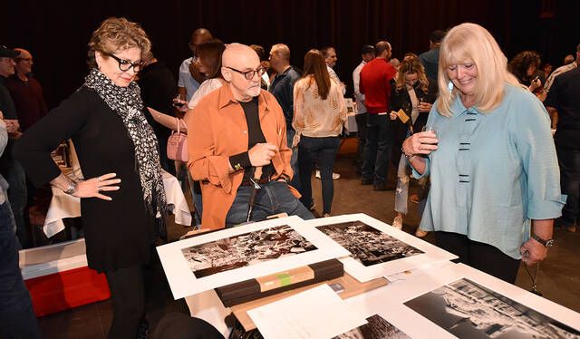 <p>Patty Martinelli, right, is checking out black and white photos from Bob Wallace Photo Group. Left to right: Debra Maslanko, Bob Wallace, Martinelli.</p>
                                 <p>Tony Callaio | For Times Leader</p>