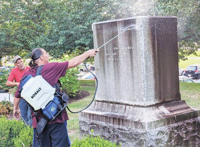 Local businessman Michael Valenteen cleans courthouse lawn