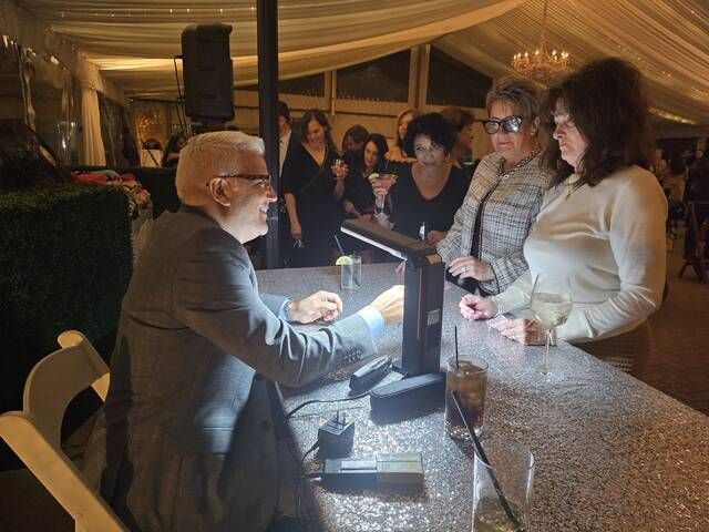 
			
				                                Emile Zafrany, of Simon & Co Jewelers, inspects a prospective diamond during Thursday night’s ‘Diamonds Downtown’ event, in which one lucky guest chose a champagne glass with an authentic diamond inside. (It wasn’t these particular guests.)
                                 Hannah Simerson | Times Leader

			
		