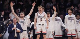 
			
				                                UConn guard Cam Spencer (12) and teammates celebrate during the final minutes of the team’s NCAA basketball game against Marquette for the championship of the Big East men’s tournament Saturday in New York.
                                 AP photo

			
		