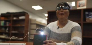 
			
				                                Minh Ha, assistive technology manager at the Perkins School for the Blind tries a LightSound device for the first time at the school’s library in Watertown, Mass., on March 2. As eclipse watchers look to the skies in April 2024, new technology will allow people who are blind or visually impaired to hear and feel the celestial event.
                                 AP Photo

			
		